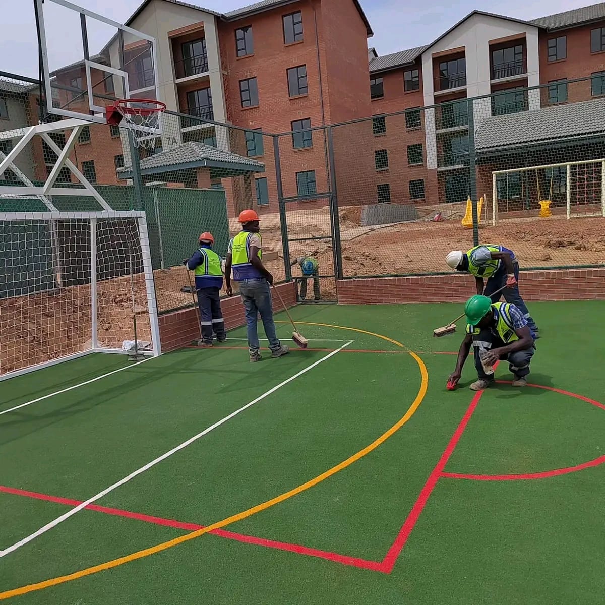 Modern Projects ZW construction crew finishing a sports court surface